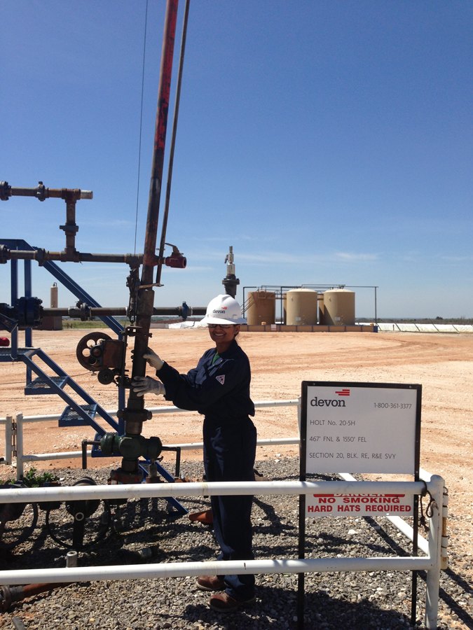 Yoshi Pradhan at a wellhead in the field
